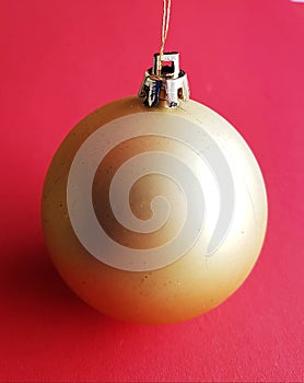 Pure and clean Christmas ball over festive redish background. Merry Xmas decoration. photo