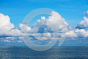 Pure clear blue sky huge white gray cloud and sunlight shiny on tropical on sea