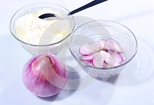 Pure curd in a glass bowl with onion