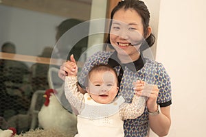 pure joy as a young Asian Chinese mother lovingly plays with her little baby girl, creating a lasting affection happiness bond -