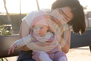 pure joy as a young Asian Korean mother lovingly plays with her little baby girl, creating a lasting affection happiness bond -