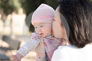 pure joy as a young Asian Korean mother lovingly plays with her little baby girl, creating a lasting affection happiness bond -