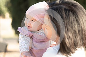 pure joy as a young Asian Korean mother lovingly plays with her little baby girl, creating a lasting affection happiness bond -