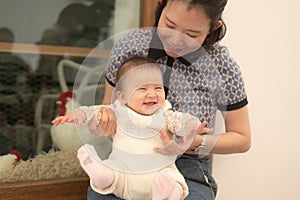 pure joy as a young Asian Korean mother lovingly plays with her little baby girl, creating a lasting affection happiness bond -