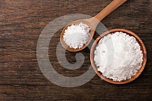 Pure natural sea salt in wooden bowl and spoon