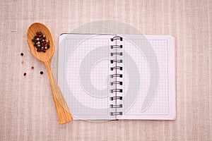 Pure notebook for recording menu, recipe on red checkered tablecloth tartan.