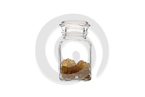 Pure Organic Frankincense Resin in a glass jar isolated on white. Natural aromatic resin used in perfumes and incenses.