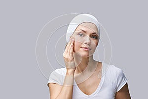 Pure skin care mature beauty portrait. Demakeup using matting tissue photo