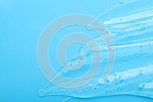 Pure transparent cosmetic gel on light blue background