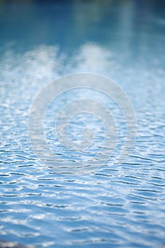 Pure water with bokeh Clean water background with calm waves Blue sky reflection