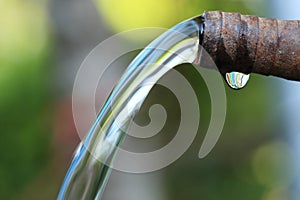 Pure Water flows from old steel pipe.