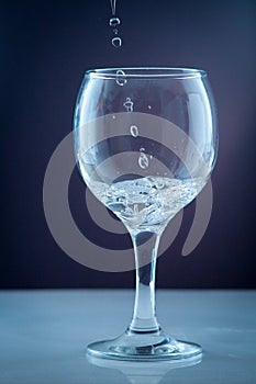 Pure water pouring into a transparent glass