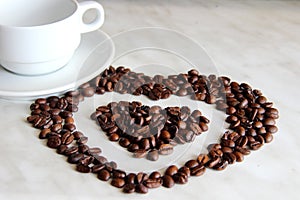 pure white Cup and saucer, lots of heart shaped coffee beans
