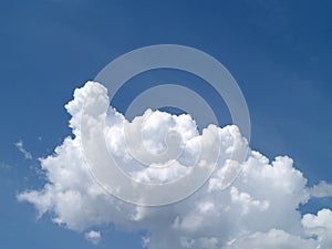 pure white fluffy clouds on brightly blue sky in sunny day