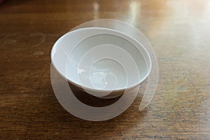 Pure white porcelain bowl on wooden table