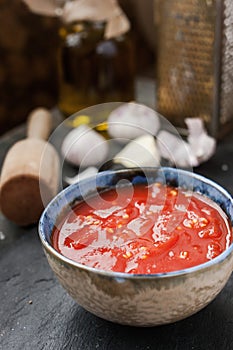 Pureed tomatoes in a ceramic dish on a table
