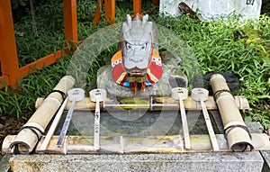 Purification ladles and a dragon statue in a shinto shrine in Japan