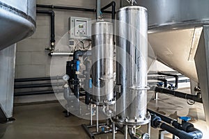Purified drinking water factory or plant, large iron tanks and water purification filters and automation filtration