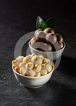 Purified macadamia nut in a white bowl against a dark background