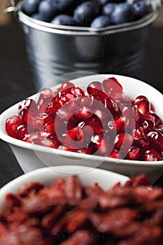 Purified pomegranate in  the bowl, close up, vertical photo.