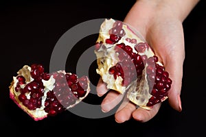 Purified pomegranate fruit in a female hand