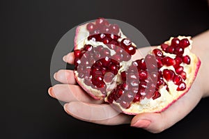 Purified pomegranate fruit in a female hand