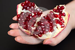 Purified pomegranate fruit in a female hand