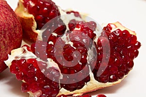 Purified pomegranate fruit on a white background