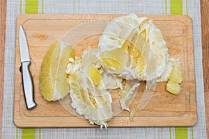 Purified pomelo lying on a wooden board