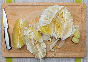 Purified pomelo lying on a wooden board