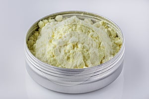 Purified sulfur powder on a white acrylic background