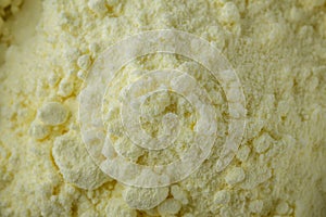 Purified sulfur powder on a white acrylic background