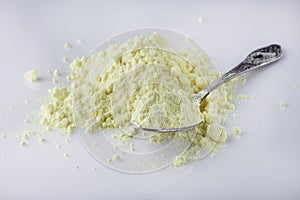 Purified sulfur powder on a white acrylic background