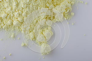 Purified sulfur powder on a white acrylic background