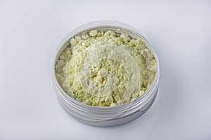 Purified sulfur powder on a white acrylic background