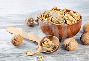 Purified walnuts in a brown wooden bowl