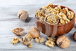 Purified walnuts in a brown wooden bowl