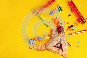 Purim background with carnival mask, party costume and hamantaschen cookies.