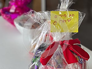 Purim basket Mishloach manot on table uring Purim Jewish holiday party
