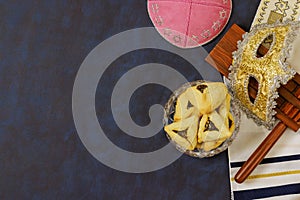 Purim is celebrated with hamantaschen, hamans ears cookies, a carnival mask, noisemakers photo