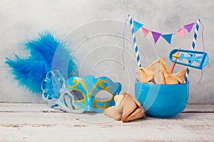 Purim celebration concept with hamantaschen cookies and carnival mask