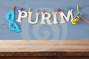 Purim celebration concept & x28;jewish carnival holiday& x29; in front of empty wooden table. product display backdrop.