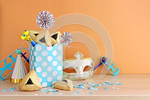 Purim celebration concept (jewish carnival holiday). Hamantaschen cookies over wooden table