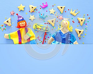 Purim celebration concept jewish carnival holiday over blue wooden background. Top view, Flat lay