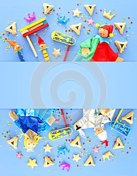 Purim celebration concept jewish carnival holiday over blue wooden background. Top view, Flat lay