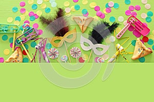 Purim celebration concept & x28;jewish carnival holiday& x29; over green wooden background. Top view. Banner.