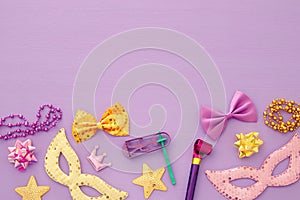 Purim celebration concept & x28;jewish carnival holiday& x29; over pink wooden background. Top view.