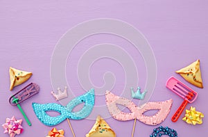 Purim celebration concept & x28;jewish carnival holiday& x29; over wooden pink background.