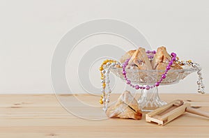 Purim celebration concept jewish carnival holiday over wooden table.