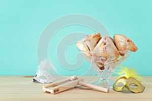 Purim celebration concept jewish carnival holiday over wooden table.